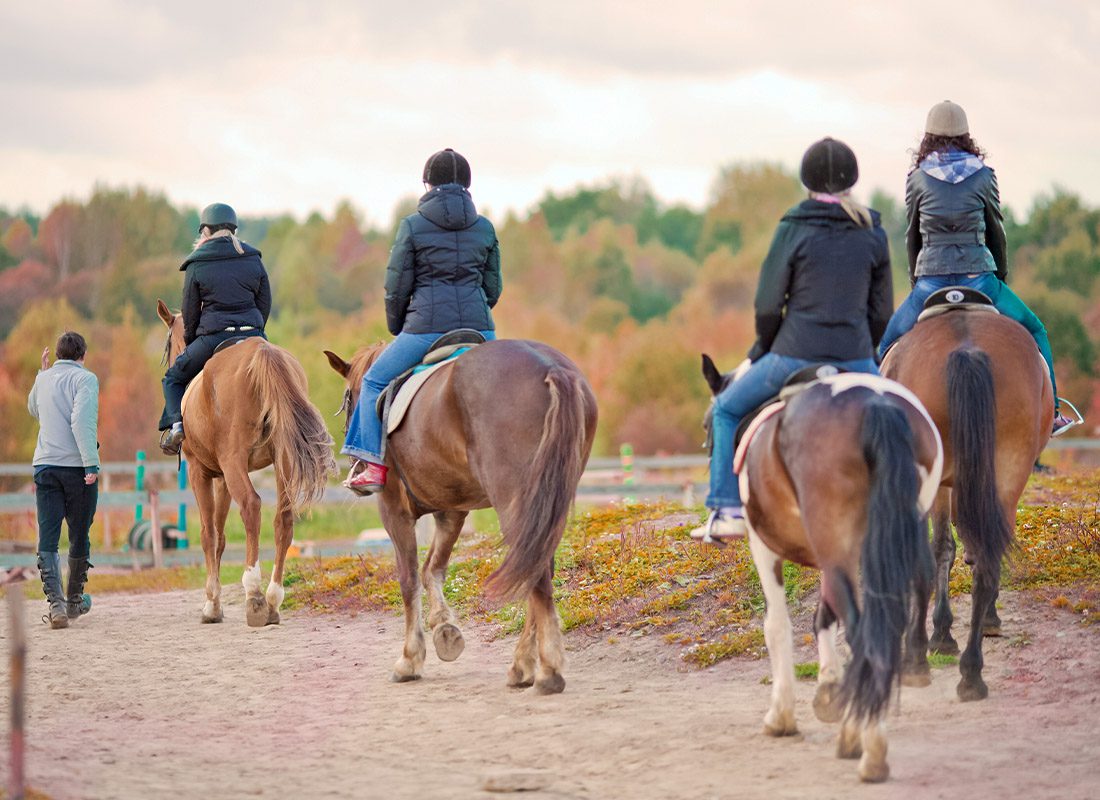 Outfitters and Guides Insurance - Horseback Riding Tour of a Ranch in Wyoming on a Sunny Day